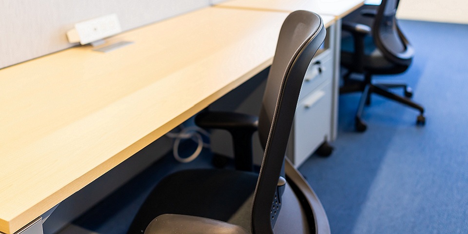 An empty desk chair at an office cubicle