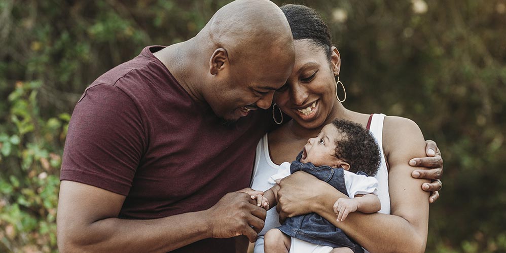 Family holding baby