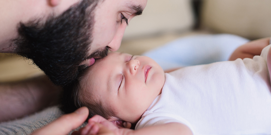 father kissing baby