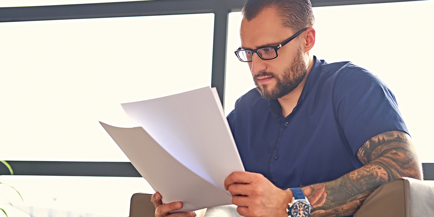 a man looking at paperwork