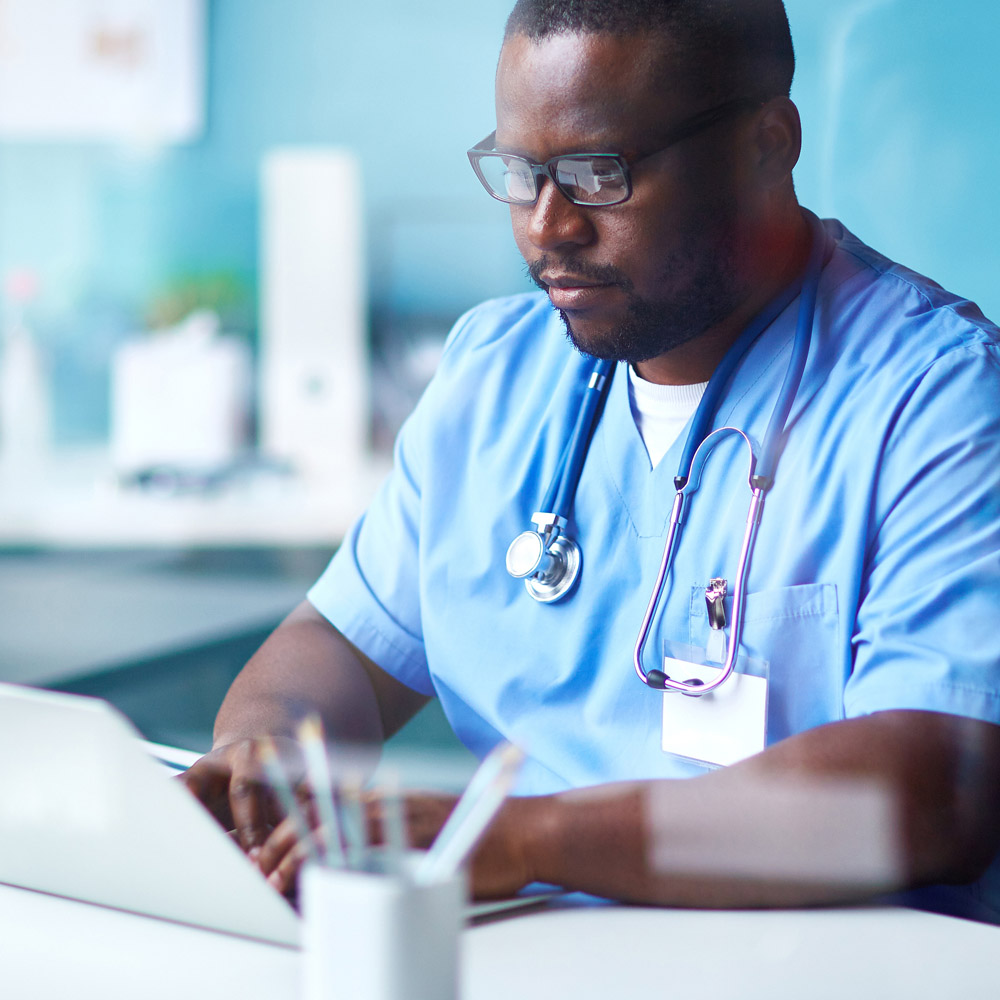 Doctor sitting at a desk in his medical office