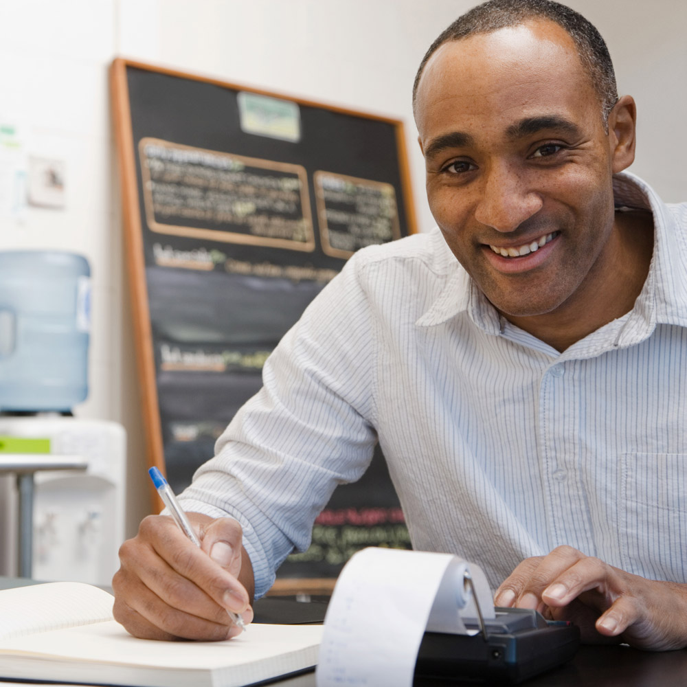 Restaurant manager doing receipts in the back office