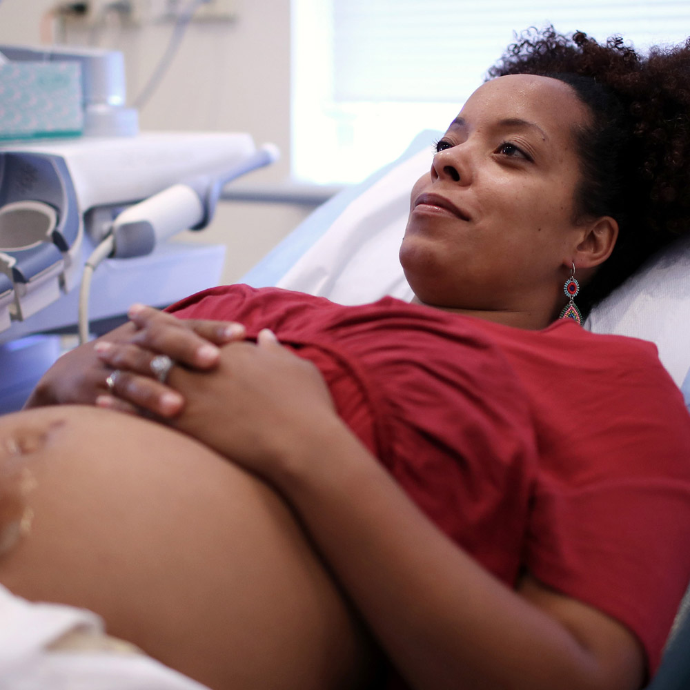 Pregnant woman at her healthcare provider's office getting an ultrasound