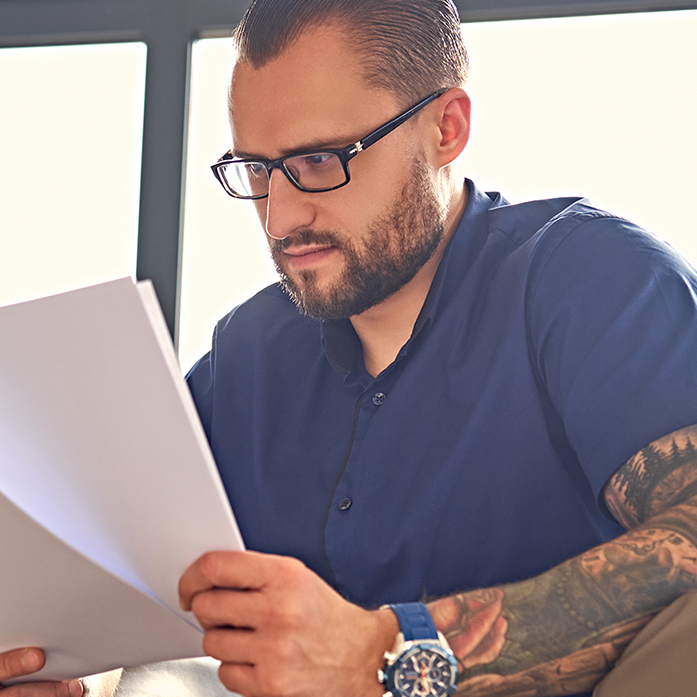 man looking at paperwork