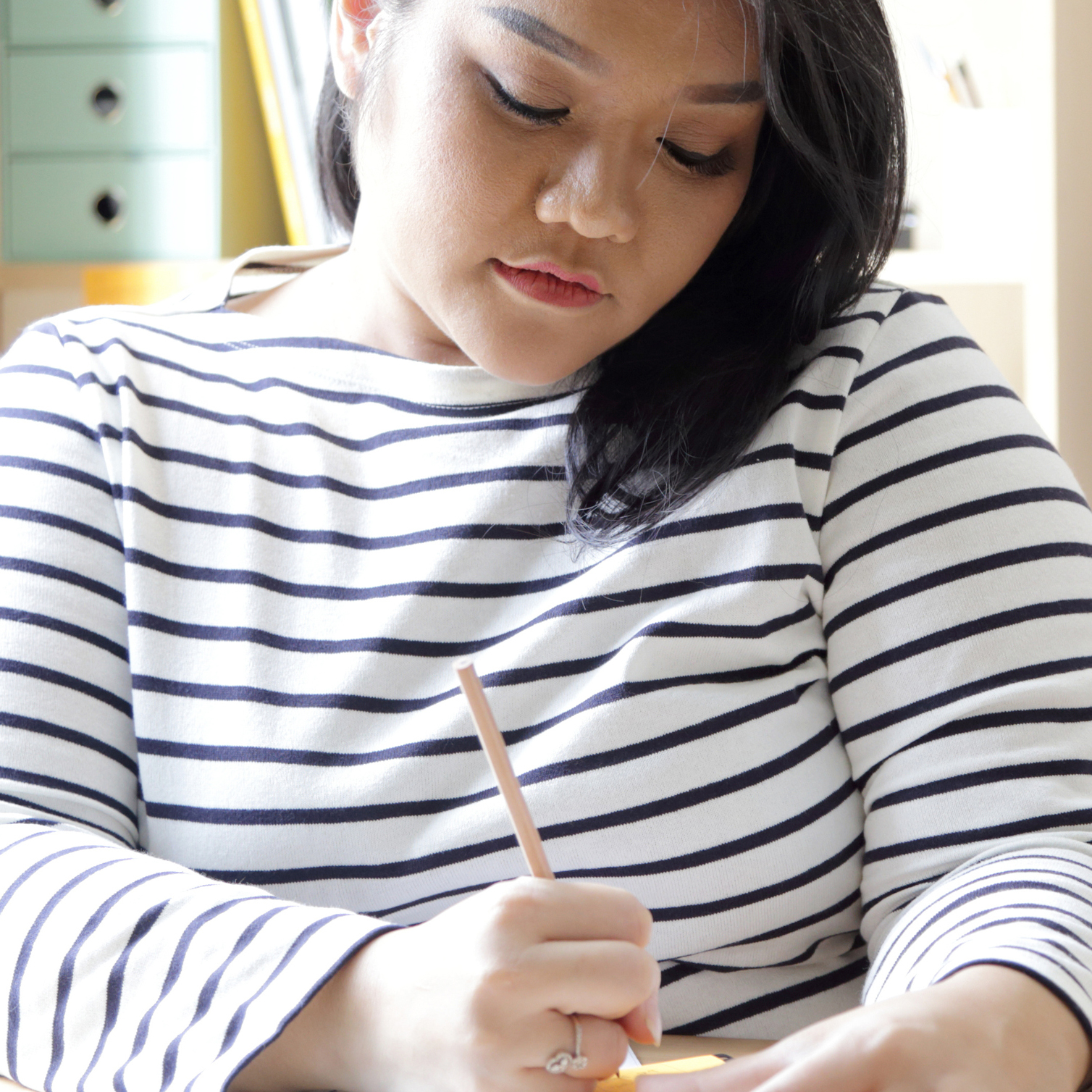 Woman at computer and writing