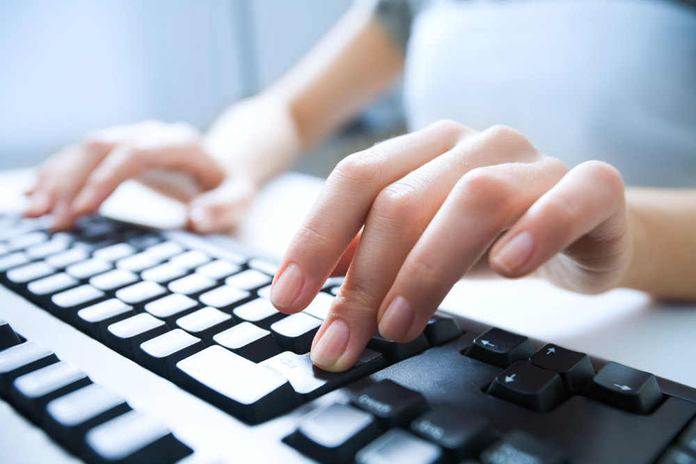 a man typing on a computer keyboard