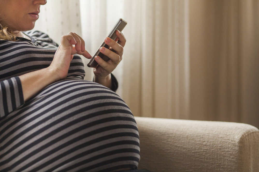 Pregnant woman using a smartphone
