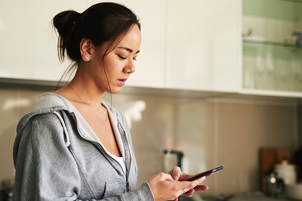 woman looking intently at her mobile phone