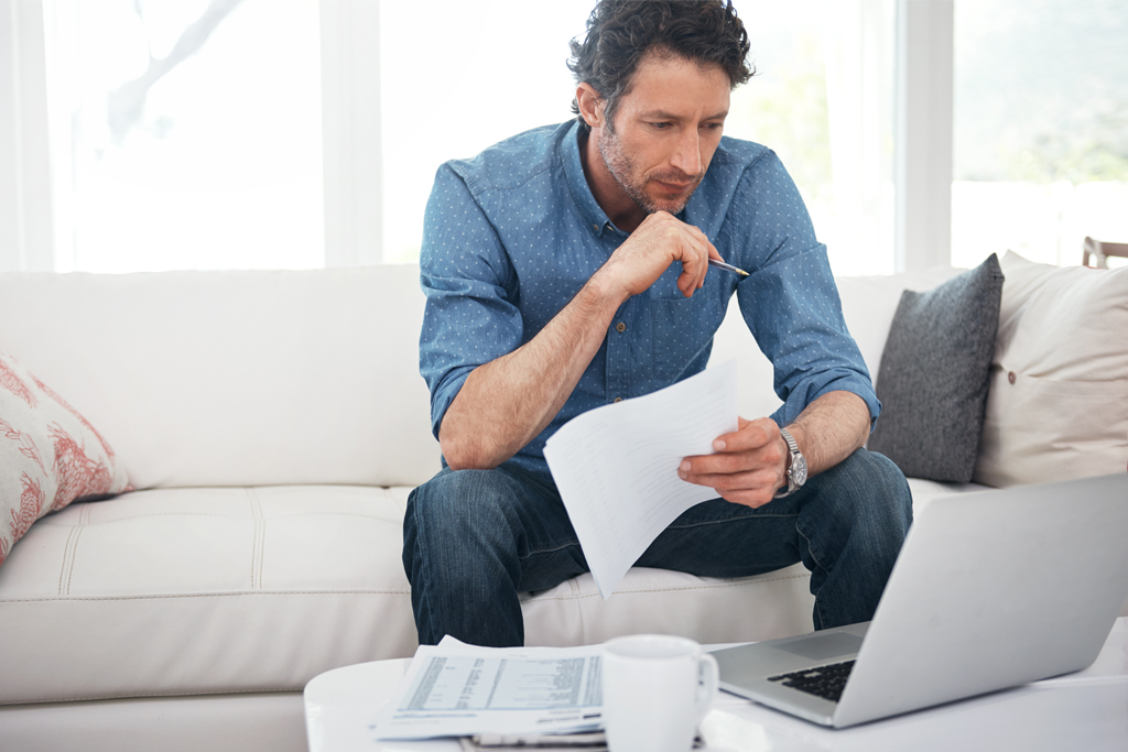 man looking thoughtful sitting on a sofa