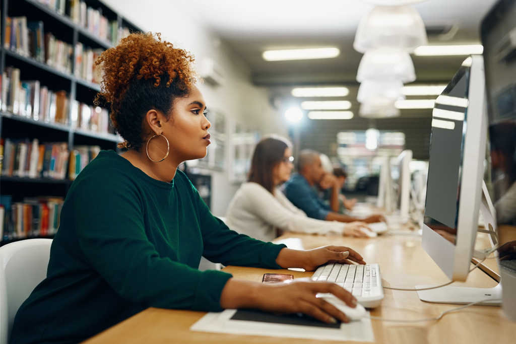 woman using a computer in a library