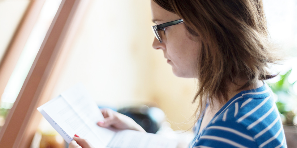 woman looking at opened mail