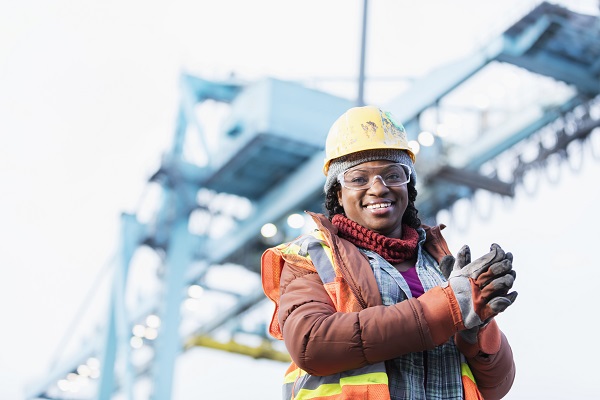 Woman in hard hat in field