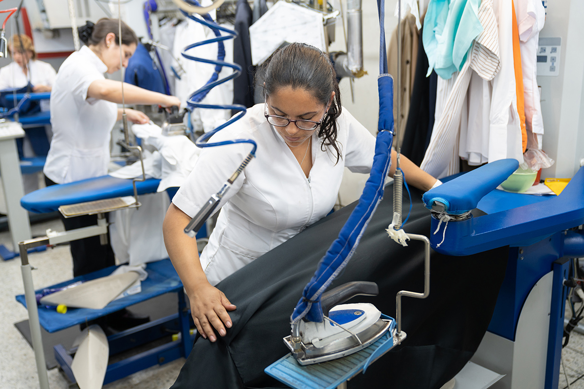 a woman working at a commercial laundry company