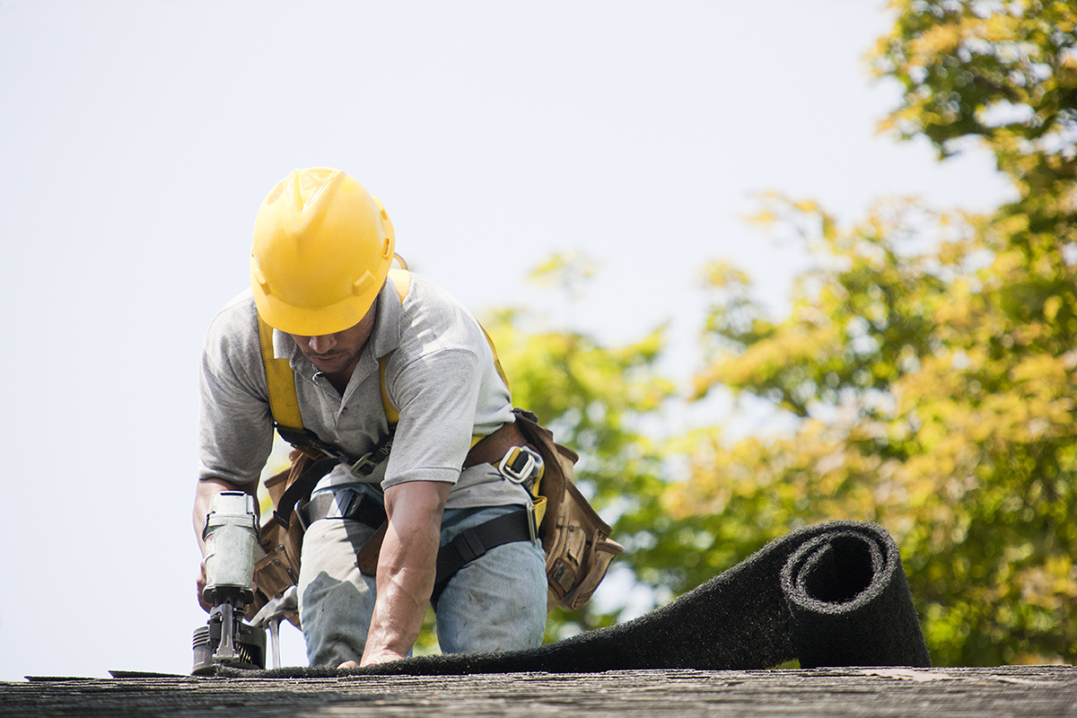 a man doing repairs on a roof