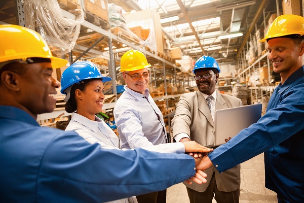 Team of workers stacking hands