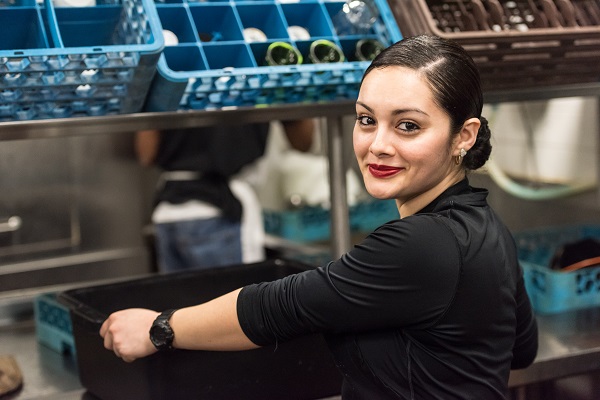 Woman working in kitchen of restaurant