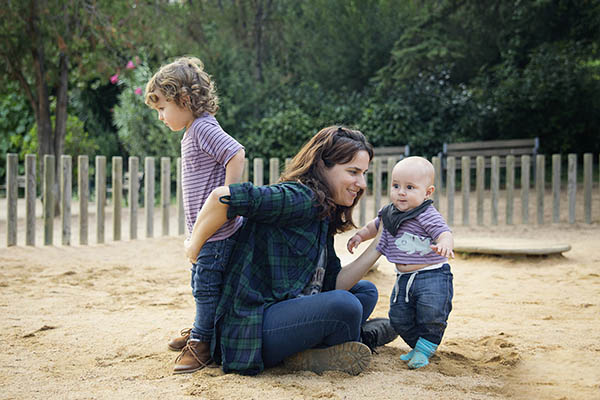 Woman with two children at playground