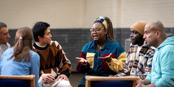 a support group of people in chairs together