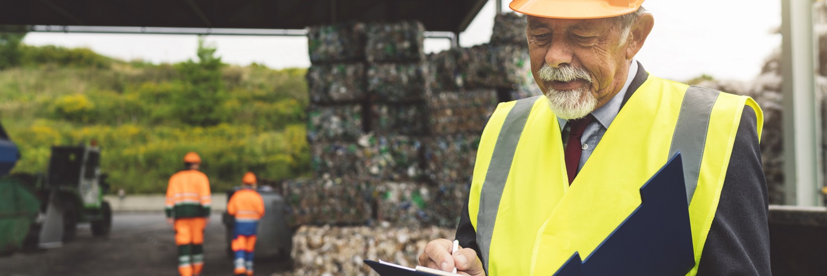 Man in hardhat at recycling facility