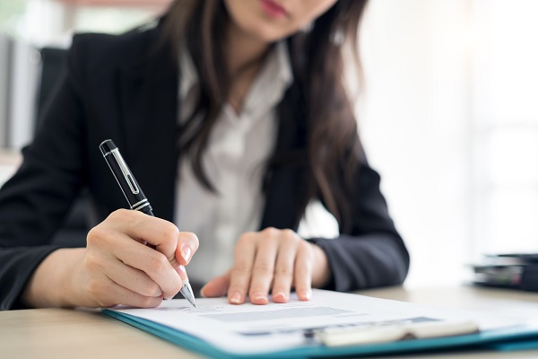 Woman signing document