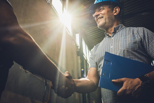 Man in hardhat shaking hands