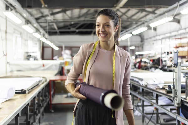 Woman smiling while holding fabric