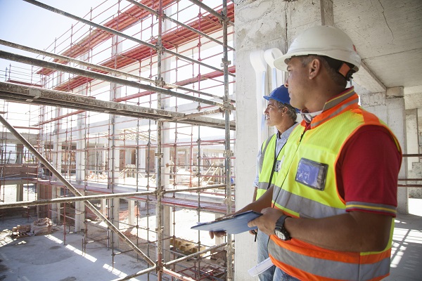 Two men looking out over a construction site