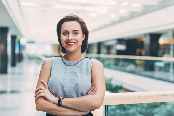 Woman standing in building with arms crossed