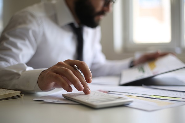 Man using calculator in office