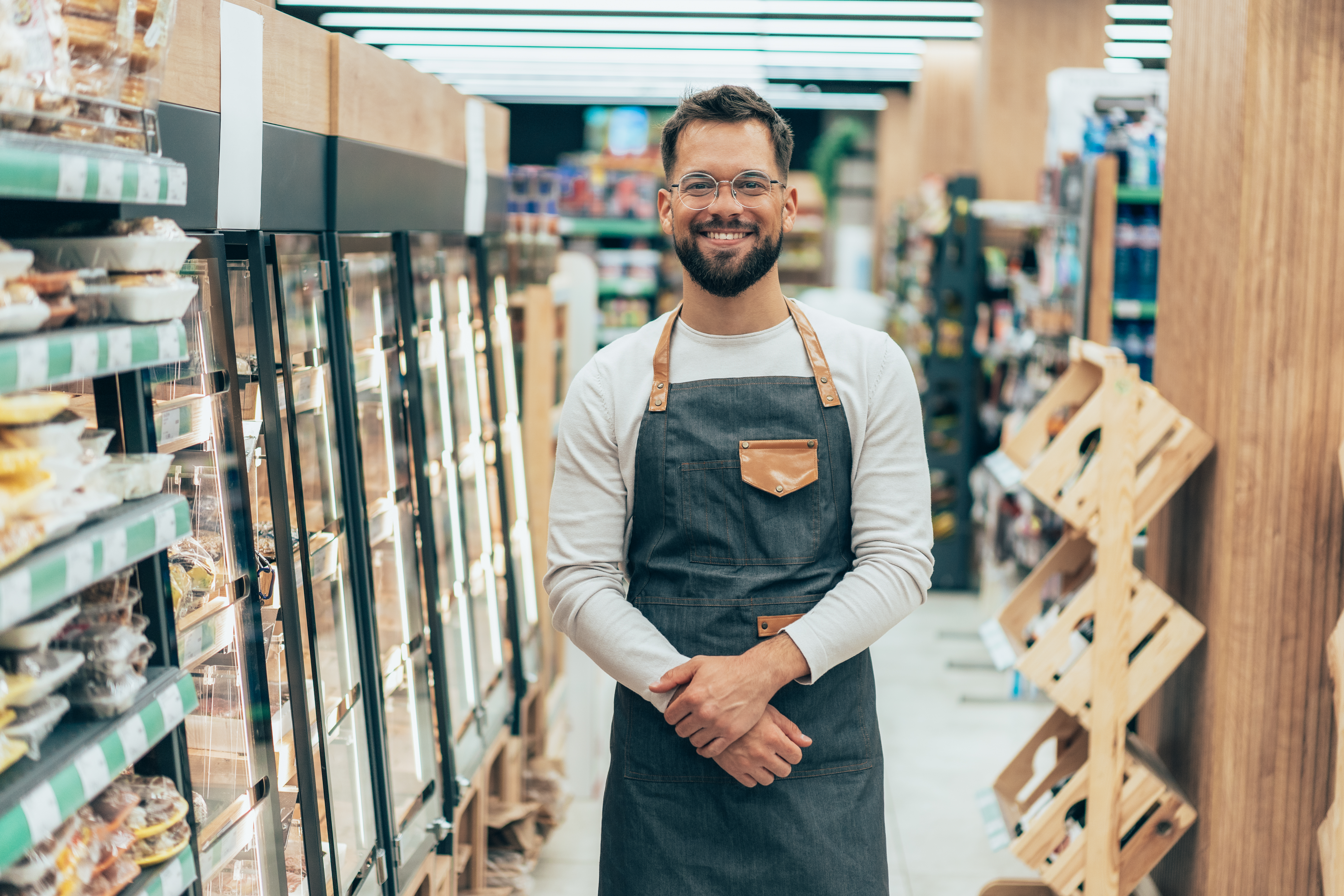 grocery store worker posing for camera