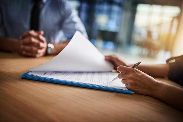 Man and woman completing paperwork together at a desk