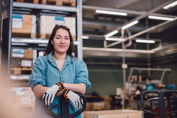 Female worker smiling at warehouse