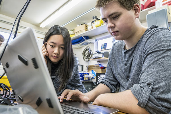 Two teenagers working at computer