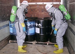 Two people inspecting hazardous waste