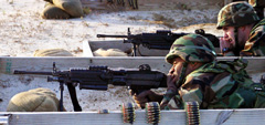 Sgt. Joseph Thorpe (front) and Capt. Michael Bobinis (back) zero their M-249s on the firing range at Fort Dix.