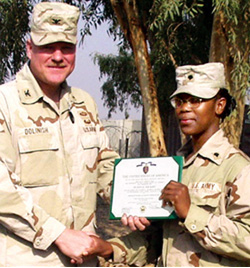 Spc. Lisa Easley (left), 150th AG Detachment, receives a safety briefing from Sgt. Joseph Thorpe (right) before heading to the firing line with her M-249.