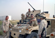 Convoy commander 1st Lt. Scott Nemeth (right) goes over last minute instructions with (l-r) Specialists William Thornborrow, Patrick Calandrillo and Bill Desain. -- Click to Enlarge