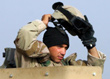 Turret gunner Spc. Patrick Calandrillo removes his Kevlar helmet upon entering the safety of the FOB after completing the first leg of the combat logistical convoy. -- Click to Enlarge