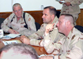 Maj. Michael Lyons (L) and Lt. Col. Roch Switlik (R), brief Maj. Gen. Glenn K. Rieth during his vist to Iraq in May, 2005.