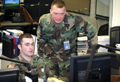 Specialists Ryan Dillon (left) and Dan Tinkler, HSCOE Members monitor the Guard's response.