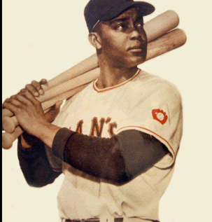 Monte Irvin standing with bats