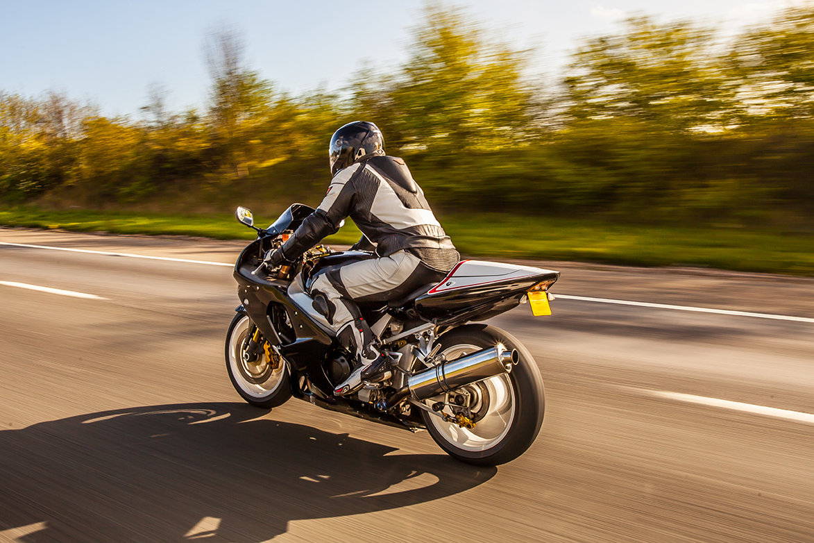 Motorcycle rider traveling safely with protective gear