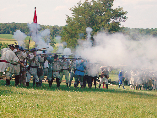 Colonial militia fire a volley at British troops during the annual Battle of Monmouth reenactment near Freehold
