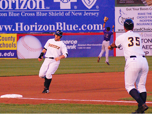 A Trenton Thunder baserunner nears third at Waterfront Park, Mercer County