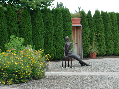 Statue of a young woman resting on bench at the Grounds for Sculpture, Hamilton