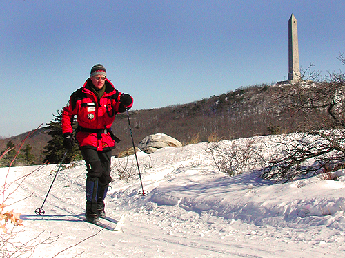 A ski patroller passes by the monument at High Point State Park, Sussex County