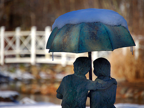 Statue of a young couple overlooks the pond at Sayen Park, Mercer County