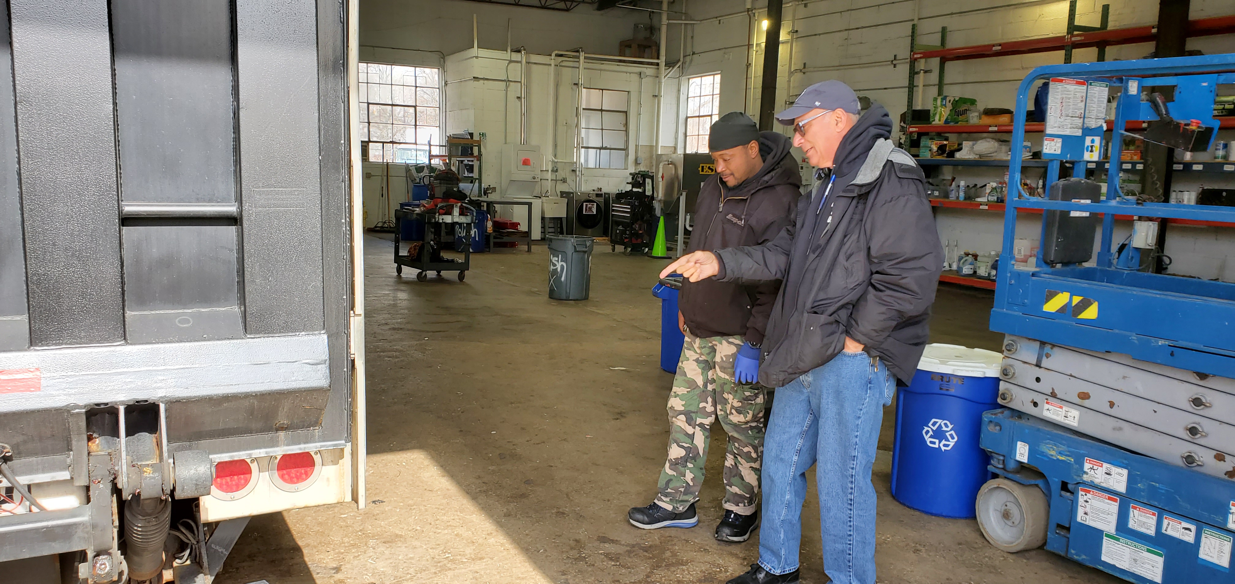 David Haddad (r) examining one of his many fleet vehicles with his NJ crew.