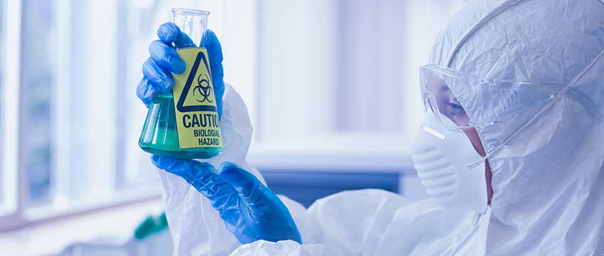 Photo of a scientist holding a flask with a chemical in it