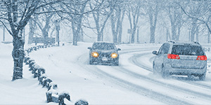 Photo of cars driving in a snow storm